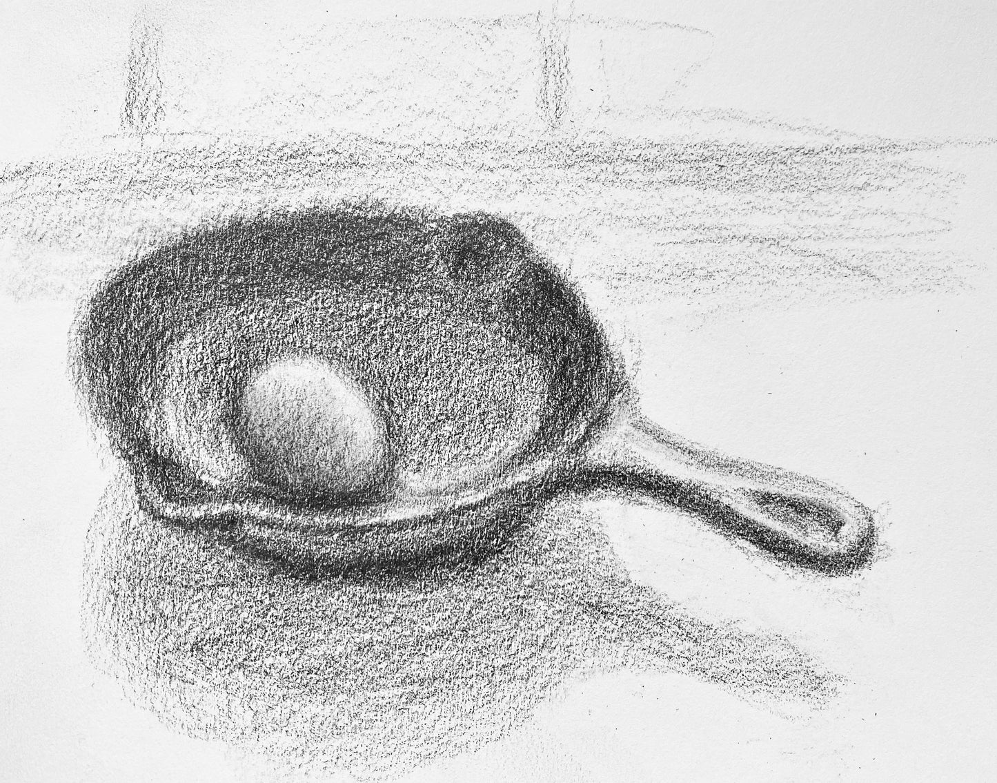 Small frying pan with egg.